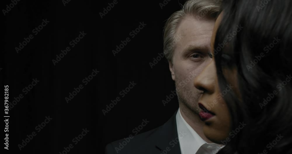 Portrait of a woman in profile and a man in the background, 4k Portrait of a woman in profile and a man in the background, 4k