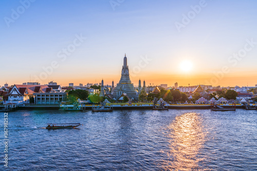 Thai Temple at Chao Phraya River Side, Sunset at Wat Arun Temple in Bangkok Thailand. Wat Arun is a Buddhist temple in Thon Buri District of Bangkok, Wat Arun is among the best known of Thai. © RoBird