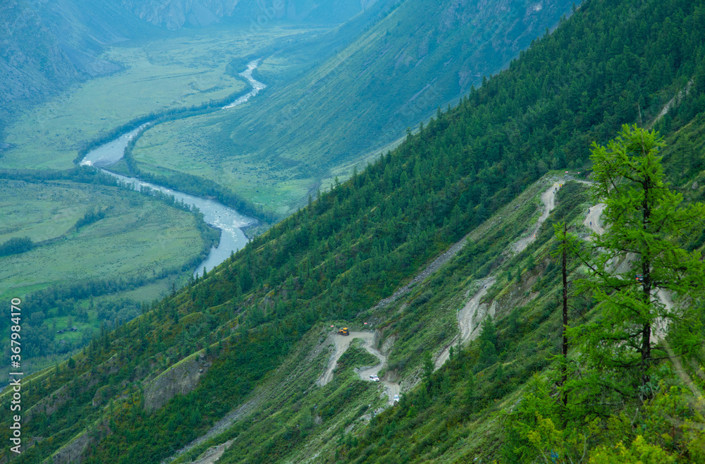 View of the gorge of the Chulyshman River and the serpentine mountain road from the Katu-Yaryk pass. Ulagansky district, Altai Republic, Russia