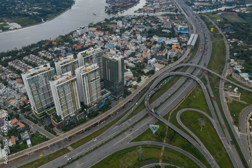 top down aerial view of highway with loops, urban and river view