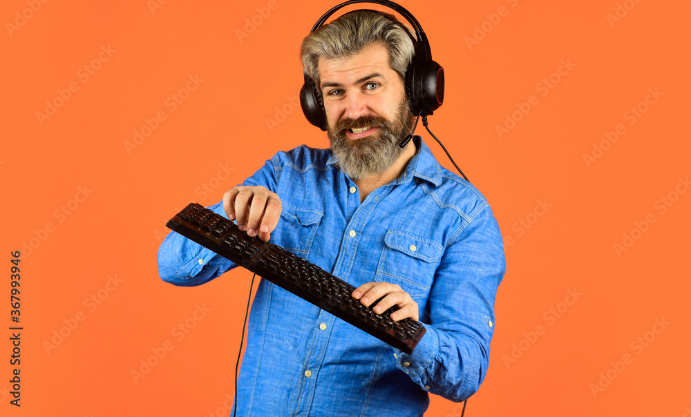 Graphics settings pushed to limit. Play computer games. Man bearded hipster gamer headphones and keyboard. Gaming PC build guide. Gaming addiction. Online gaming. Modern leisure. Run any modern game Graphics settings pushed to limit. Play computer games. Man bearded hipster gamer headphones and keyboard. Gaming PC build guide. Gaming addiction. Online gaming. Modern leisure. Run any modern game