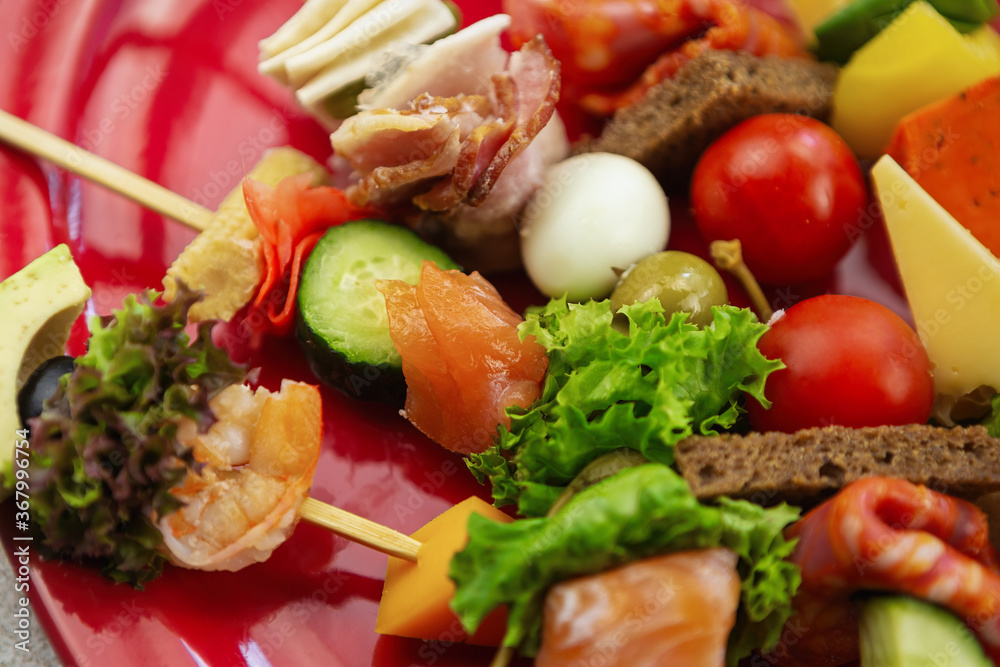 Delicious antipasto food on sticks shot in close up.Fresh tapas snacks for wine party Delicious antipasto food on sticks shot in close up.Fresh tapas snacks for wine party