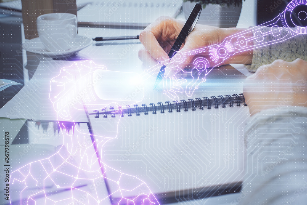 Fototapeta premium AR hologram over hands taking notes background. Concept of augmented reality. Double exposure