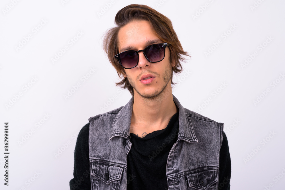 Young handsome rebellious man against white background Young handsome rebellious man against white background