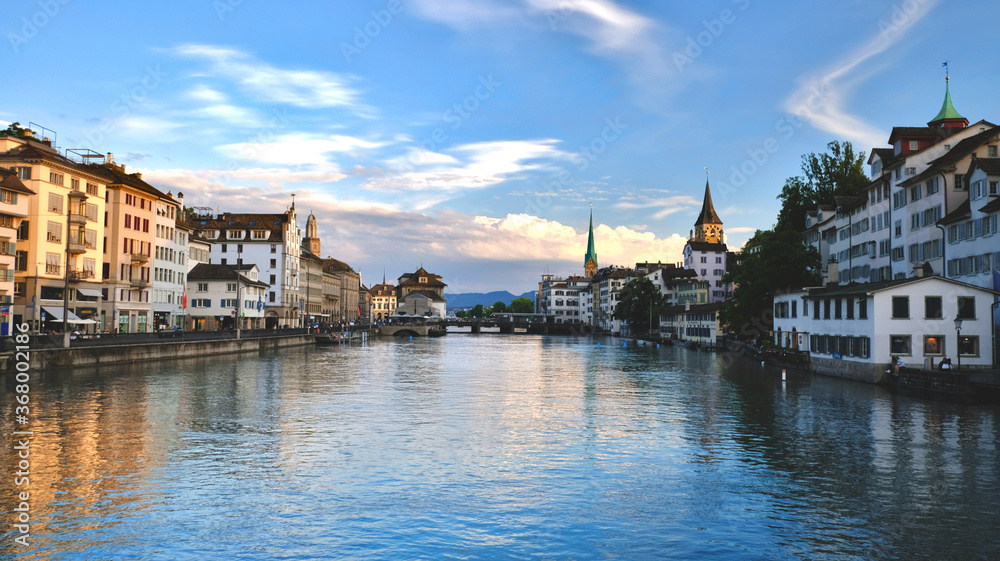 Switzerland: Zurich river Limmat landscape at sunset, view on the old buildings of the city