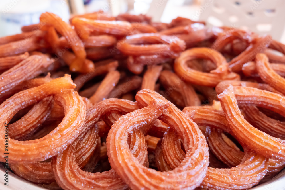 Turkish Dessert Churros Halka Tatli frying in hot oil. Turkish Dessert Churros Halka Tatli frying in hot oil.