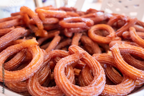 Turkish Dessert Churros Halka Tatli frying in hot oil.