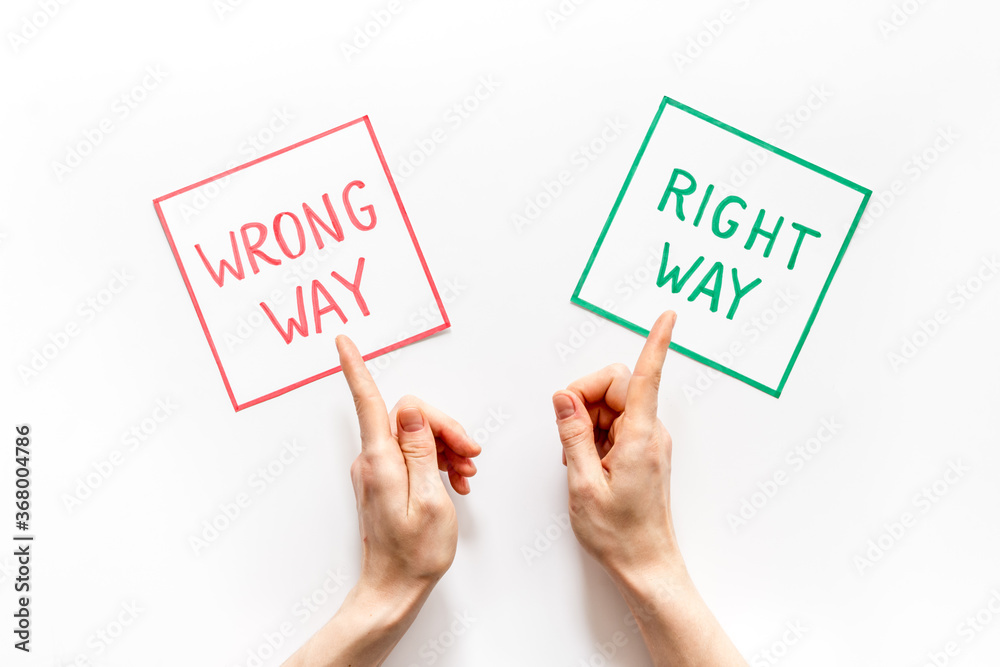 Choice concept. Right and wrong way icons, female hands shows top view