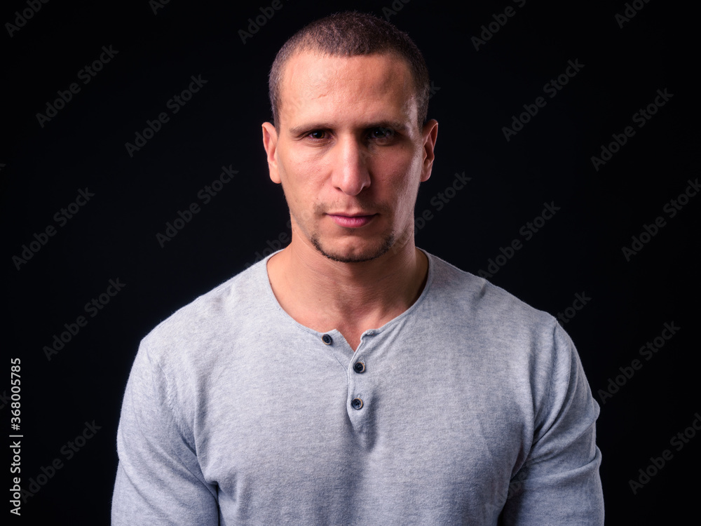 Face of man with short hair against black background Face of man with short hair against black background