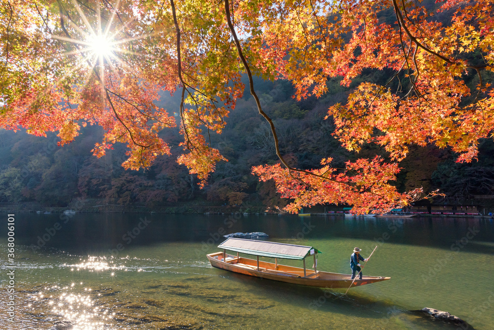 Naklejka premium Beautiful nature view of Arashiyama in autumn season along the river in Kyoto, Japan. Arashiyama is a one of attraction landmark for tourist in Kyoto, Japan