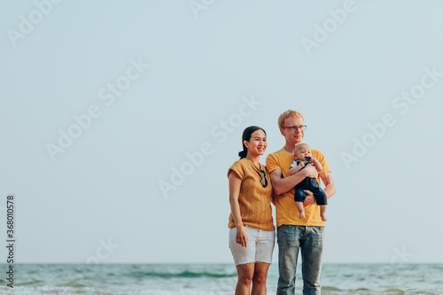 Happy family on the beach.  Father, mother and baby having fun on summer vacation. Holiday travel concept © Charnchai saeheng