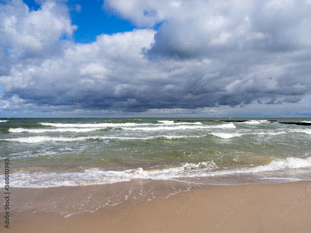 strong swell at the Baltic Sea and the sky is blue and cloudy