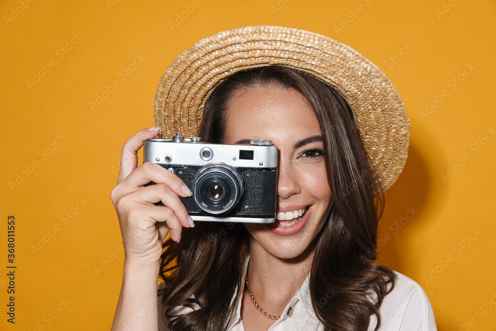 Image of cheerful nice woman using retro camera and smiling Image of cheerful nice woman using retro camera and smiling