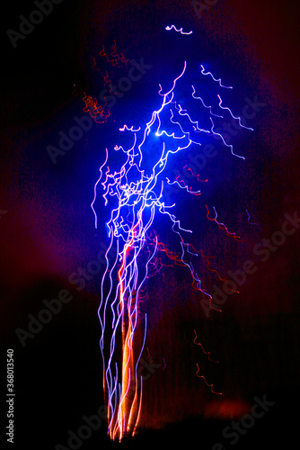Digitally enhanced photo taken at slow shutter speed pf an exploding firework.