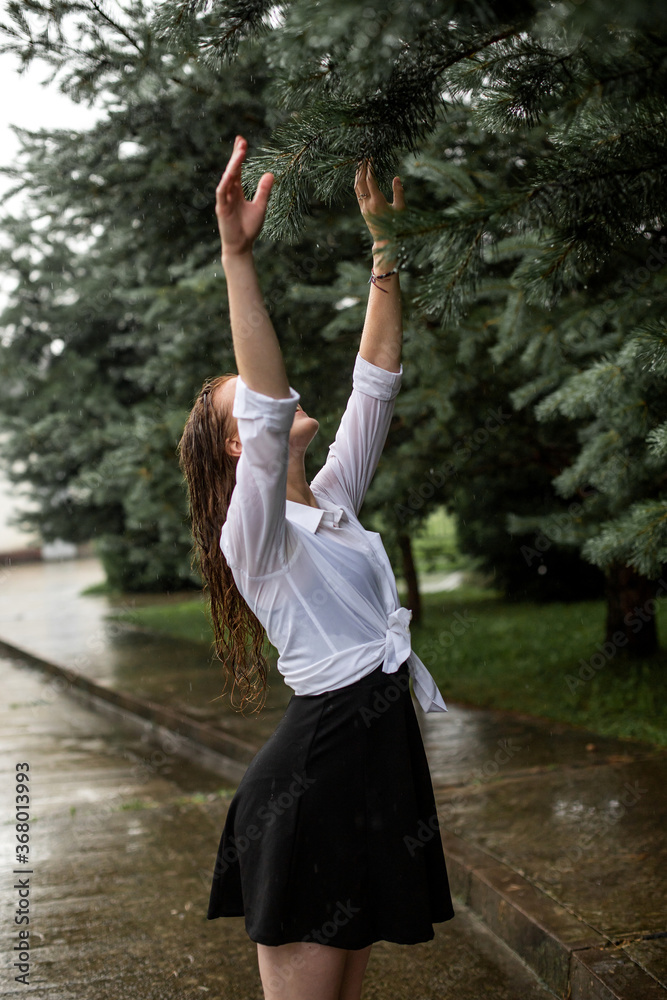 young woman walking on the street in the rain