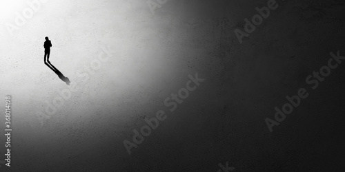Silhouette of man walking in the night toward the light, view from above. Way of life, going nowhere. Flyer with copyspace. Mind and art concept, loneliness, freedom of choice. Abstract illustration.