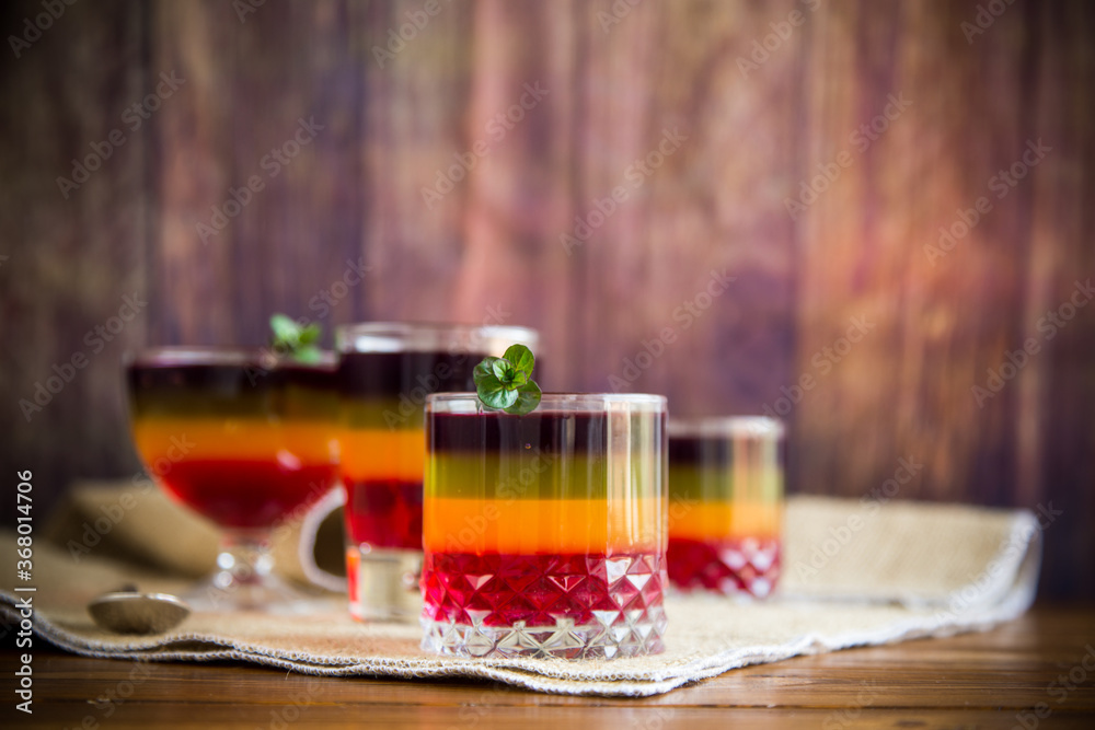 Sweet multi-colored fruit puff jelly in a glass cup Sweet multi-colored fruit puff jelly in a glass cup