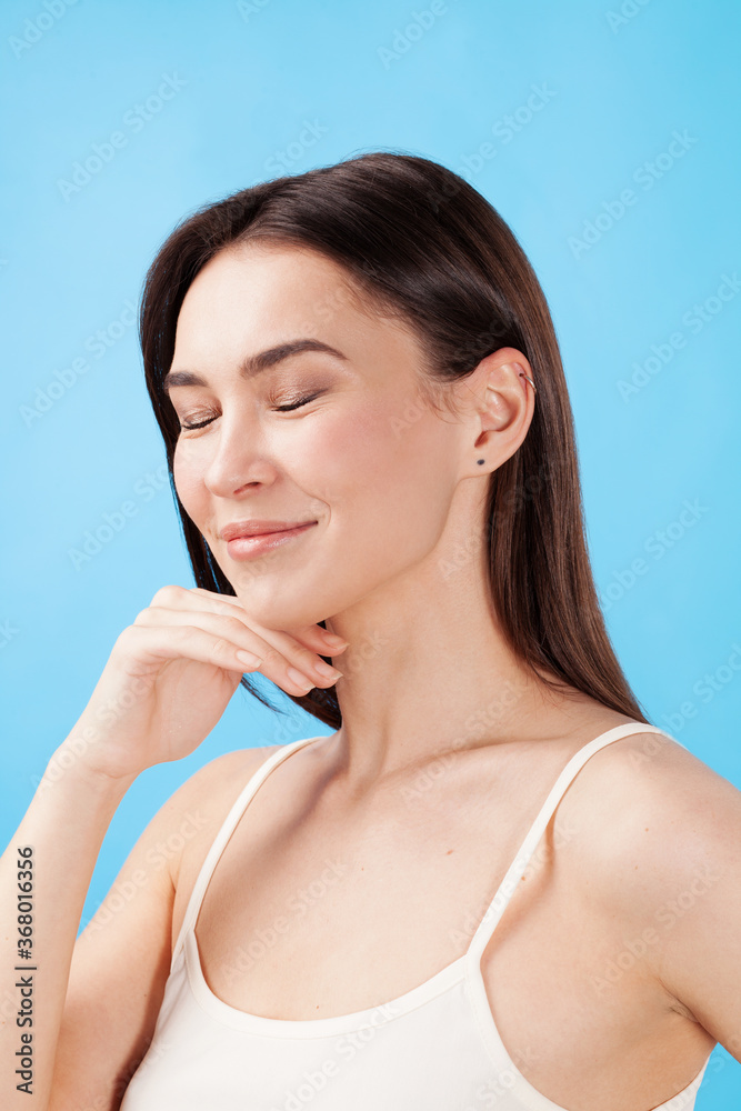 Lovely young woman with healthy skin against blue background Lovely young woman with healthy skin against blue background