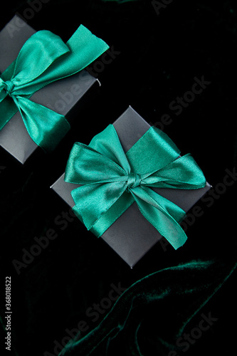 Luxury black gift boxes with green ribbon © bondarillia