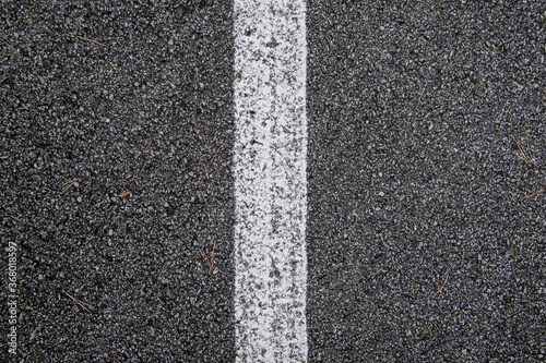 White line painted on asphalt, texture.