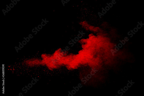Abstract red powder on black background. Red color clouds.