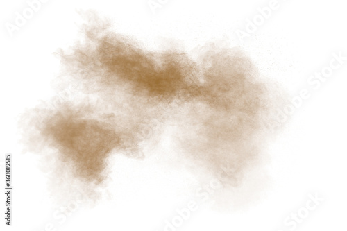 Freeze motion of brown dust explosion. Stopping the movement of brown powder. Explosive brown powder on white background. Dry soil splater on white background.