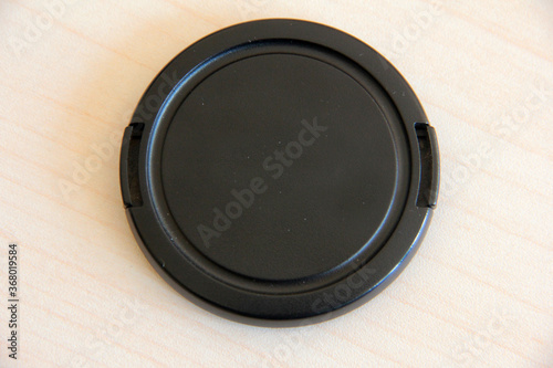black lens cap on white background