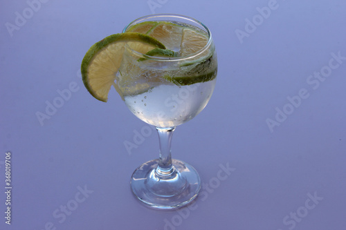 mineral water and lemon in a glass cup