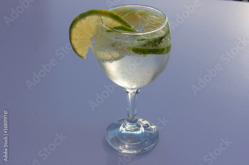 mineral water and lemon in a glass cup