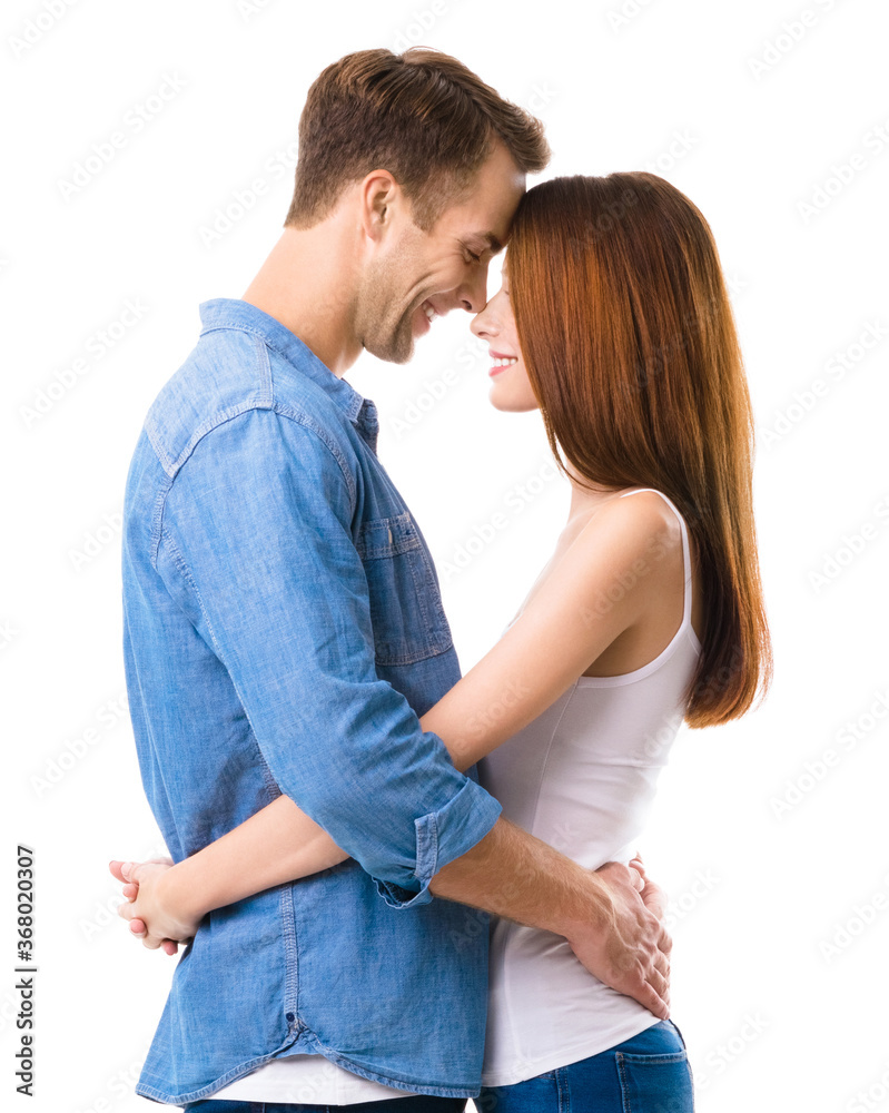 Profile side of smiling happy couple. Portrait image of standing close and looking at each other models in love studio concept, isolated against white background. Man and woman together. Profile side of smiling happy couple. Portrait image of standing close and looking at each other models in love studio concept, isolated against white background. Man and woman together.
