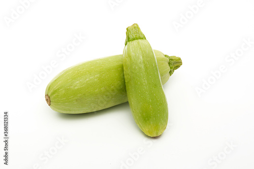 Fresh vegetable marrow are standing. Isolated on white background.
