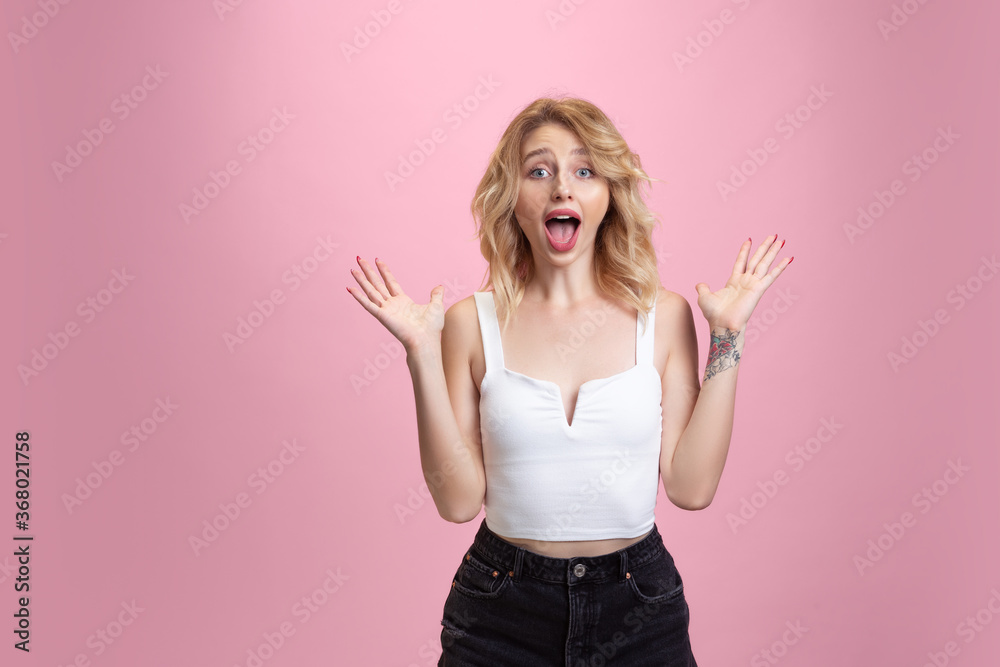 Shocked, surprised, astonished. Caucasian young woman's portrait isolated on pink studio background. Beautiful blonde model. Concept of human emotions, facial expression, sales, ad, youth. Copyspace. Shocked, surprised, astonished. Caucasian young woman's portrait isolated on pink studio background. Beautiful blonde model. Concept of human emotions, facial expression, sales, ad, youth. Copyspace.