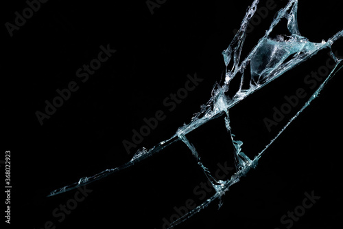 broken mirror glass on a colored and black background in cracks in the form of an isolated image abstraction