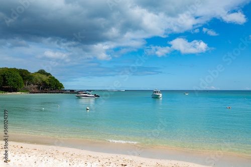 tropical beach with boats on the island of Mauritius.