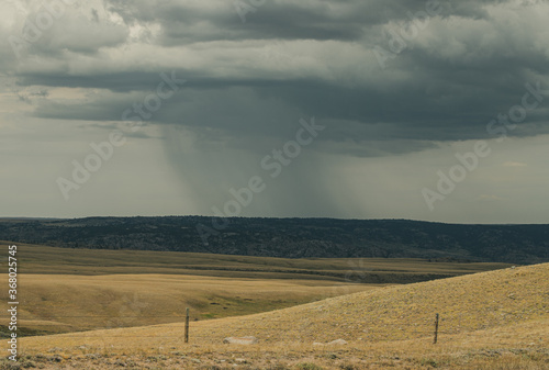 landscape with heavy rain in the distance