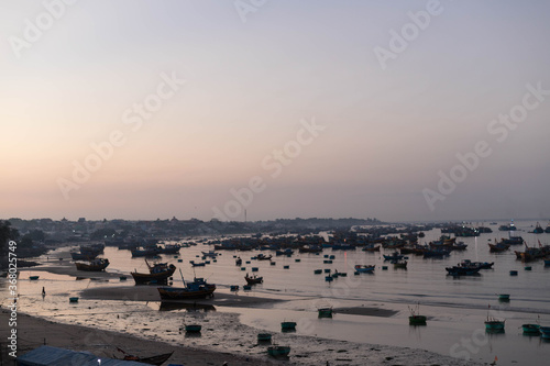 MUI NE / VIETNAM - December 28, 2019 :  view on Fishing village and traditional fishing boat with hundreds boats anchored ( fishing harbour market) photo