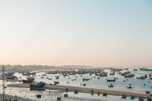 MUI NE / VIETNAM - December 28, 2019 : view on Fishing village and traditional fishing boat with hundreds boats anchored ( fishing harbour market)