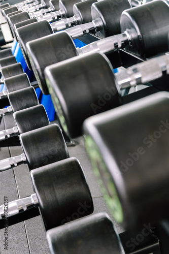 Close up image of Fitness equipment dumbbells weight Gym background  