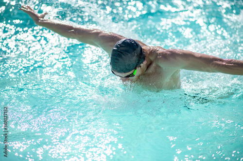 Man in swimming cap having a workout in pool