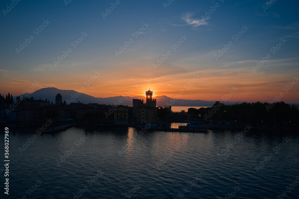 Sunrise over the castle of Sirmione, Lake Garda, Italy. Aerial view