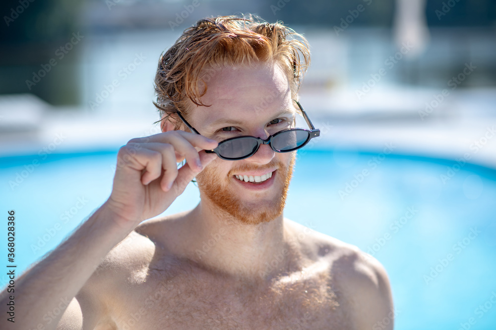 Young successful smiling bearded man in sunglasses Young successful smiling bearded man in sunglasses