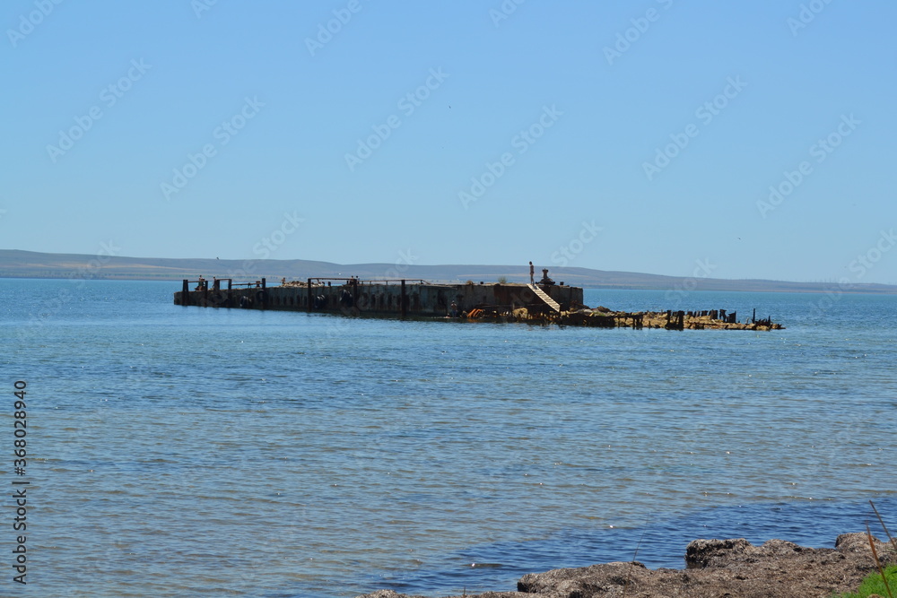 a sunken barge in the black sea on a summer day blue sky