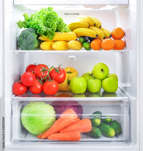 Fototapeta Naklejka Na Ścianę i Meble -  Open fridge full of vegetables and fruits