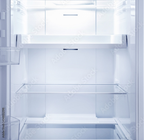 Empty open fridge interior photo