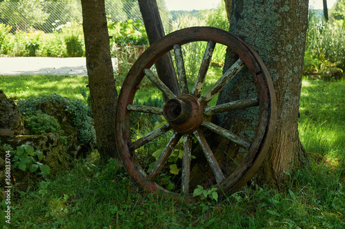 an old wooden wheel in the grass