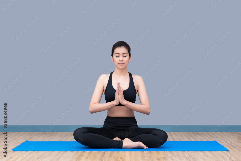 Asian woman practicing yoga pose at yoga healthy sport gym, yoga and meditation have good benefits for health Asian woman practicing yoga pose at yoga healthy sport gym, yoga and meditation have good benefits for health