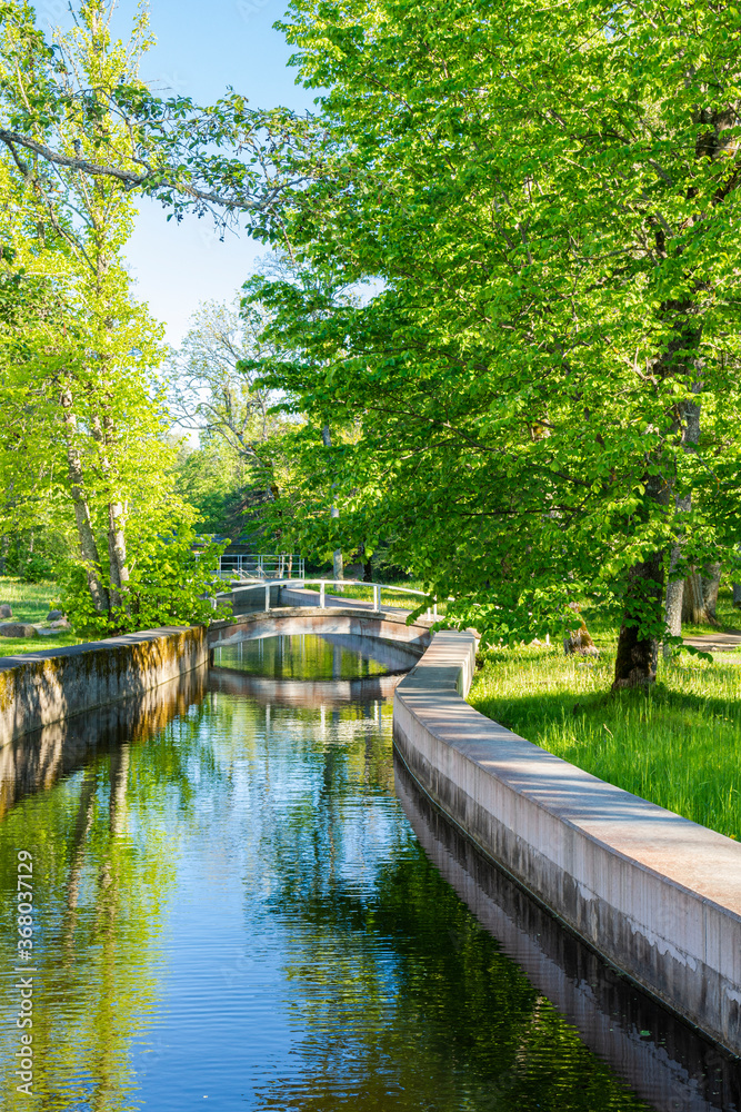 View of the Keila-Joa Park in summer, walking bridge over the river, Estonia