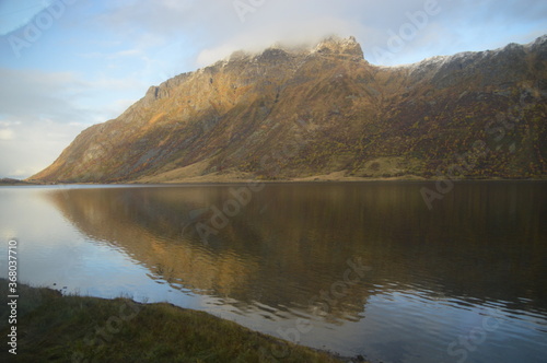 Autumn colors and reflections in the Norwegian mountains of the Lofoten Fjords in Norway