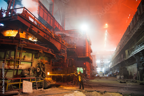 Metal structures and buildings of the old metallurgical plant inside and outside. The process of melting metal. Products of the metallurgical enterprise.