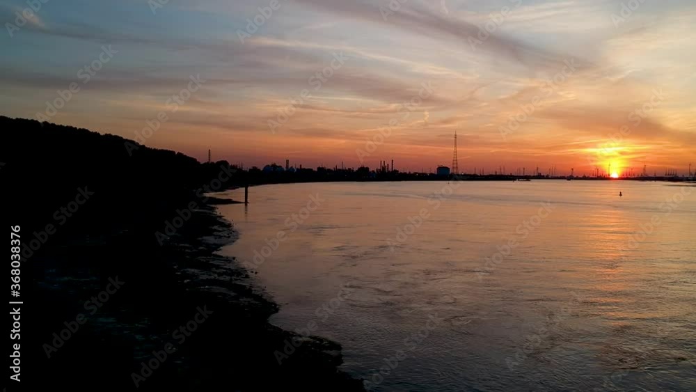 The Antwerp International Port. Sunset. Titlt up drone shot. Bridge Silhouette. The Antwerp International Port. Sunset. Titlt up drone shot. Bridge Silhouette.